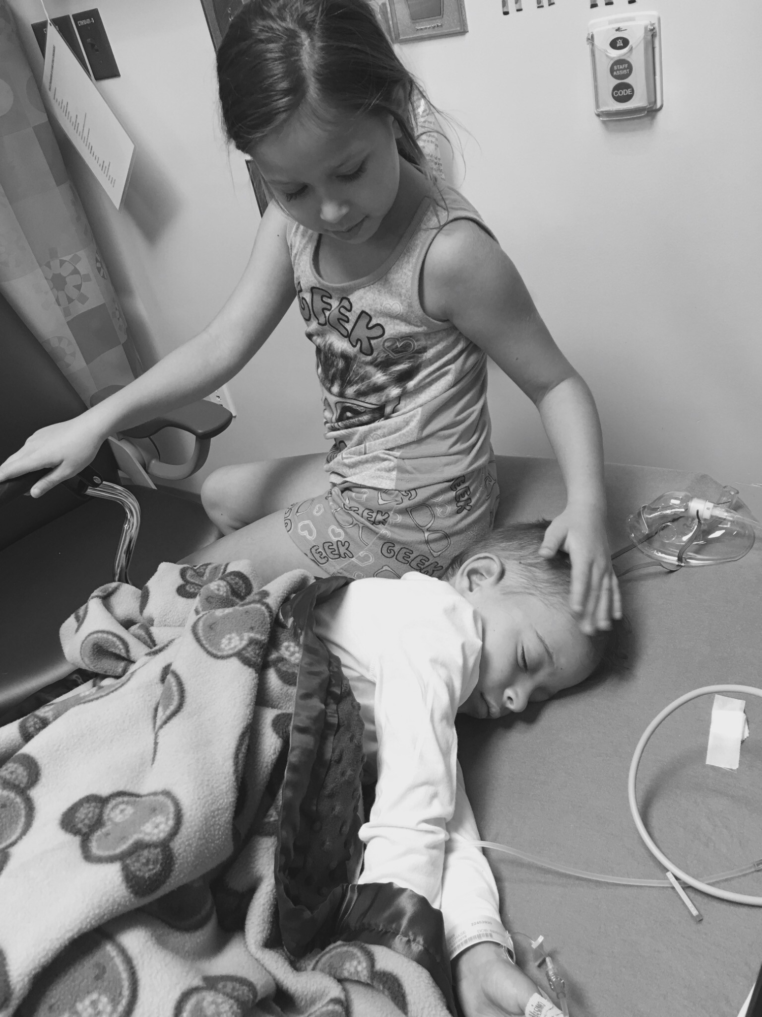 Young Emma comforting Chase during a hospital visit