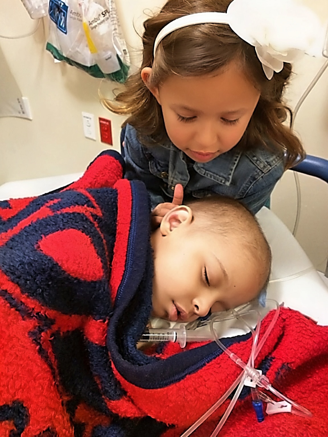 Young Emma beside Chase during treatment